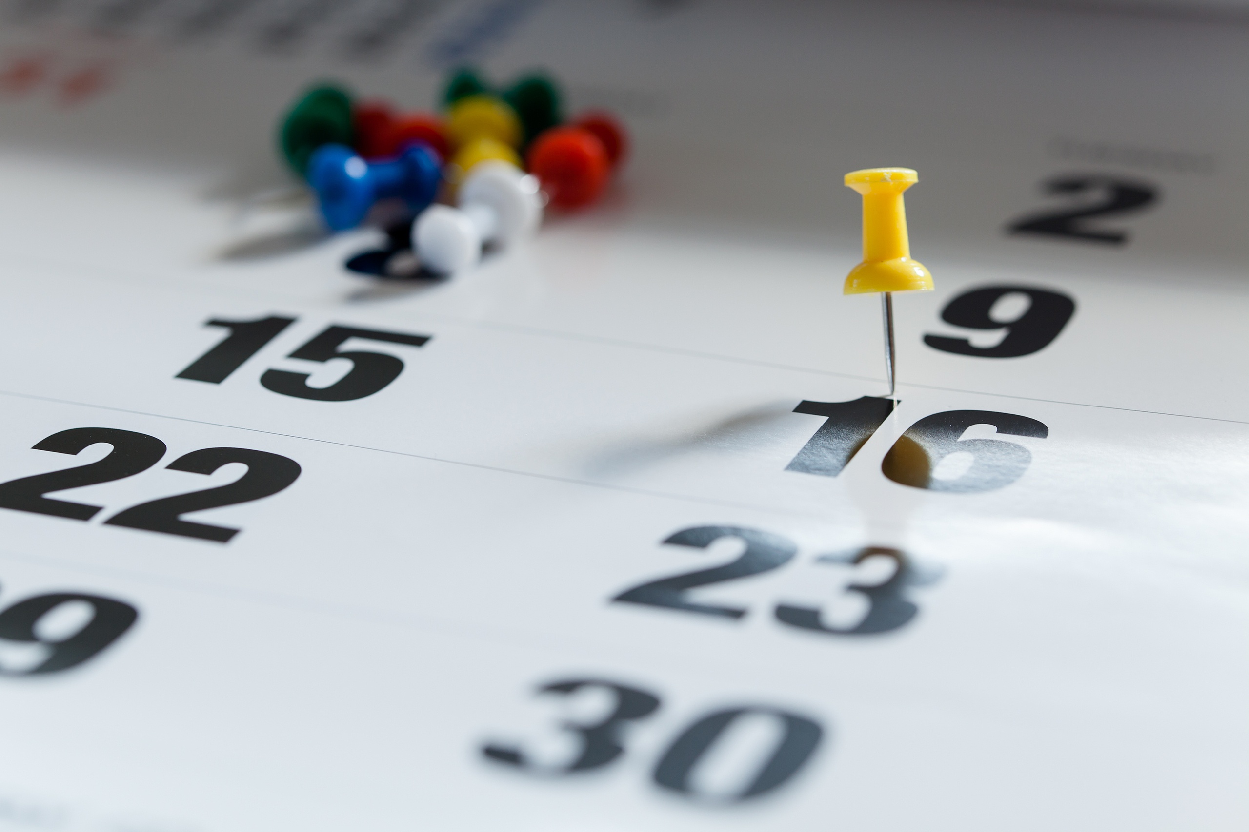Pushpins on calendar, Busy and overworking days. Important date or meeting appointment reminder concept.